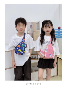 Detail showing kids navy dinosaur and pink unicorn print chest bags with adjustable straps