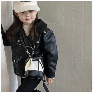 Close-up of kids' leopard print contrast bucket bag and black faux leather biker jacket