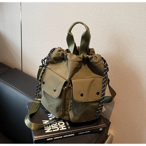 Detail of army green nylon bucket bag with cargo pockets and mixed color drawstring