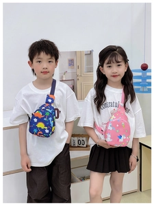 Detail of dinosaur and unicorn print crossbody chest bags on kids with adjustable straps