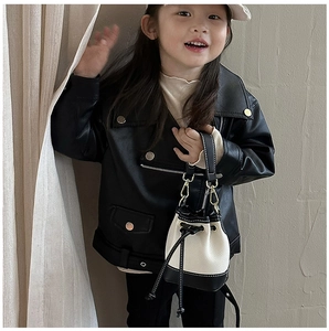 Close-up of kids black leather jacket with a black and white drawstring bucket bag