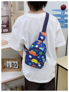 Detail of cute cartoon dinosaur print on a navy blue kids crossbody chest bag