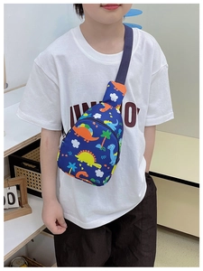Close-up of kids dinosaur print chest bag in navy canvas with adjustable strap and zip