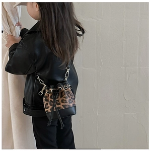 Detailed view of leopard print mini bucket bag with leather trim and gold hardware