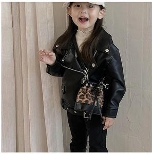 Detail of kids black faux leather biker jacket paired with a mini leopard bucket bag
