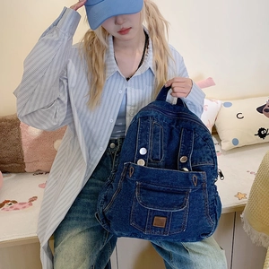 Large dark blue washed denim backpack with vintage texture and multiple pockets for women