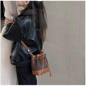 Detail of kids mini bucket bag with pebbled leather texture and drawstring closure