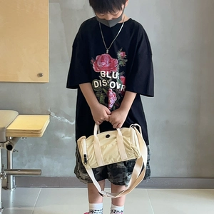 Minimalist beige cylindrical crossbody bag for kids with adjustable strap and handles