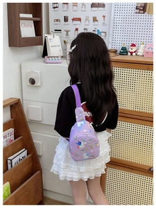Rear view of a child wearing a purple unicorn chest bag in a cozy home setting