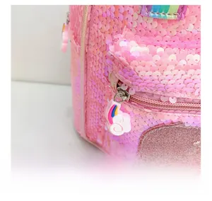 Detail of pink sequin backpack featuring a cute rainbow cloud silicone zipper puller