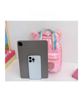 Pink sequin unicorn backpack size comparison with tablet showing storage capacity