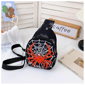 Close-up of black spider crossbody bag with red logo on a stylish desk background