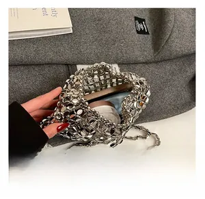 Detail of silver metallic hollow woven bag showing spacious interior for phone and cosmetics