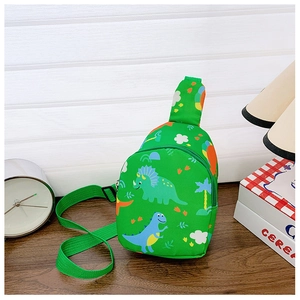 Detail of green canvas kids chest bag featuring colorful dinosaur prints and smooth zipper