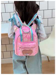 Detail of pink sequin kids backpack featuring 3D unicorn ears and rainbow shoulder straps