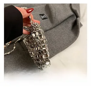 Detailed macro of silver metal disc chainmail weave and sturdy hardware hook