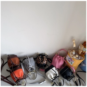 Detailed shot of various mini bucket bags in leopard print and contrasting colors