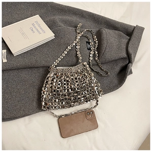 Close-up of metallic silver disc woven texture and reflective surface of the evening bag