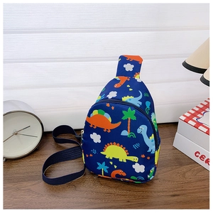 Detail of blue kids chest bag with colorful dinosaur print on a wooden desk