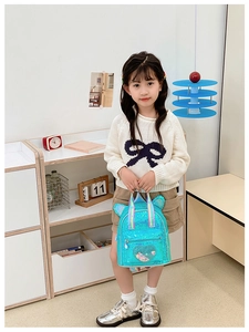 Kids sequin backpack with cat ears and heart patch shown in a cozy nursery room setting