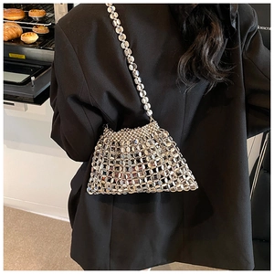 Detailed view of silver metal sequin woven bag featuring a reflective mirror finish