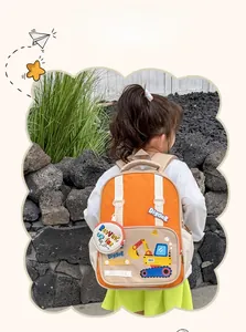 Close-up of kids cartoon excavator backpack featuring a cute orange and beige design