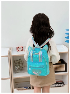 Detail of blue sequin kids backpack featuring unicorn ears and rainbow shoulder straps