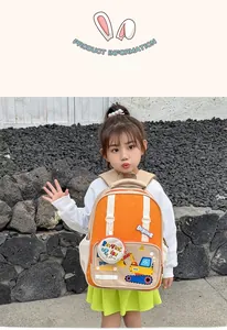 Outdoor shot of kid backpack with cartoon digger print and orange beige patchwork