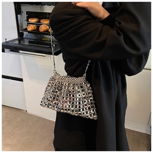 Detailed close-up of silver sequin woven chain bag with metallic circular mesh texture