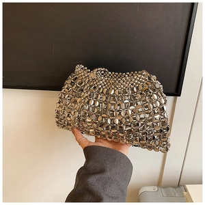 Detail of silver metallic sequin mesh clutch bag showing the reflective ring link structure
