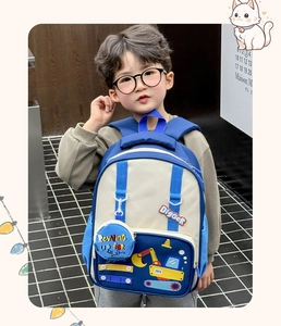 Detail of cartoon excavator embroidery and matching zip pouch on kids backpack