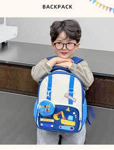 Detail of cute blue and white children's backpack with cartoon digger embroidery design