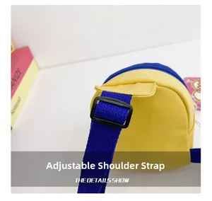 Detail of adjustable blue woven strap with durable black plastic buckle on yellow nylon bag