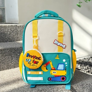 Detail of cartoon excavator embroidery on a blue and yellow kids' backpack outdoors