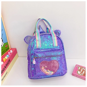 Detail of unicorn backpack with rainbow straps and shimmering heart-shaped glitter pocket