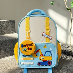Close-up of kids cartoon excavator backpack in blue and yellow on outdoor steps
