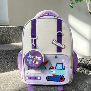 Detail of purple cartoon excavator backpack for kids with matching round charm on stairs