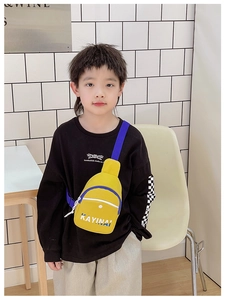 Kid wearing yellow crossbody chest bag with blue strap and letter print detail