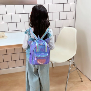 Kids purple sequin backpack with animal ears and rainbow straps on a young girl