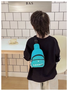 Detail of teal nylon messenger bag with white KAYINAI lettering and adjustable black strap