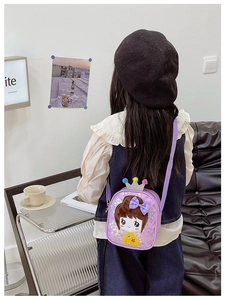 Detail view of purple sequin kids crossbody bag with cartoon girl and crown