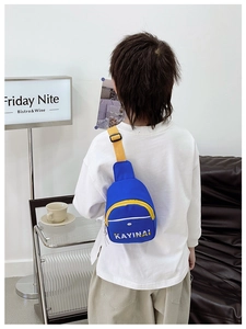 Rear view of a child wearing a stylish blue chest bag with yellow adjustable strap