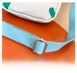 Detail view of the adjustable light blue nylon shoulder strap with a silver metal buckle