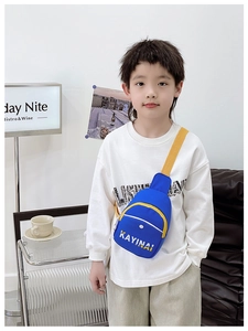 Detail of royal blue kids chest bag with adjustable yellow strap and letter print