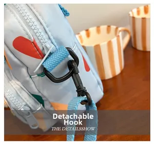 Macro shot of durable metal detachable hook and blue woven strap on kids crossbody bag