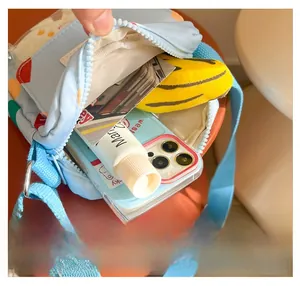 Internal view of a light blue children's canvas crossbody bag showing spacious capacity
