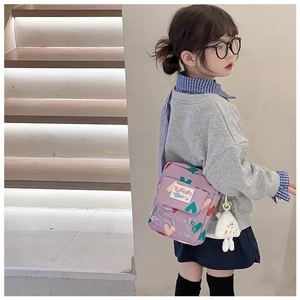 Detail of purple crossbody bag with colorful hearts, clear pocket and plush charm