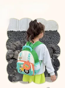 Detail of cute green and orange tractor backpack showing the mesh side pocket and 3D charm