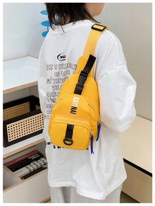 Detail view of yellow nylon kids chest bag with adjustable strap and buckle closure