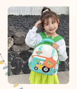 Detail view of cartoon tractor backpack for kids with a round coin purse on side mesh pocket